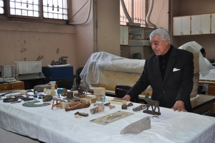 Dr. Zahi standing in front of objects in the conservation lab in the Egyptian Mueum, Cairo. (PHOTO: Stephanie Sakoutis)