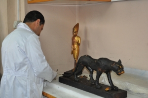 A restorator working on the statue of Tutankhamun standing on a panther. (PHOTO: Stephanie Sakoutis)
